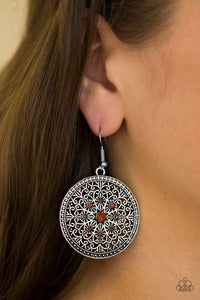 Paparazzi Catch A Chill - Brown Shimmery silver filigree swirls into an ornate snowflake pattern. Glittery rhinestones are pressed into the ornate center for a regal finish. Earring attaches to a standard fishhook fitting.

