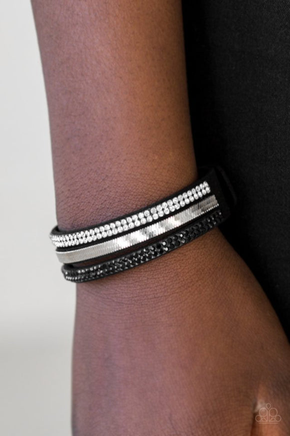 Paparazzi I Mean Business - Black - Bracelet  -  A black suede band is spliced into three strands featuring rows of glittery black rhinestones, flat silver chain, and glassy white rhinestones for a glamorous look. Features an adjustable snap closure.
