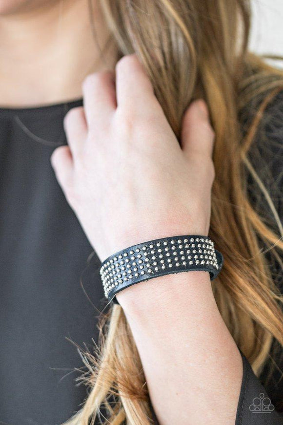 Paparazzi Road Pilot - Blue Dainty metallic beads are pressed across the front of a blue leather band for a rugged look. Features an adjustable snap closure.

