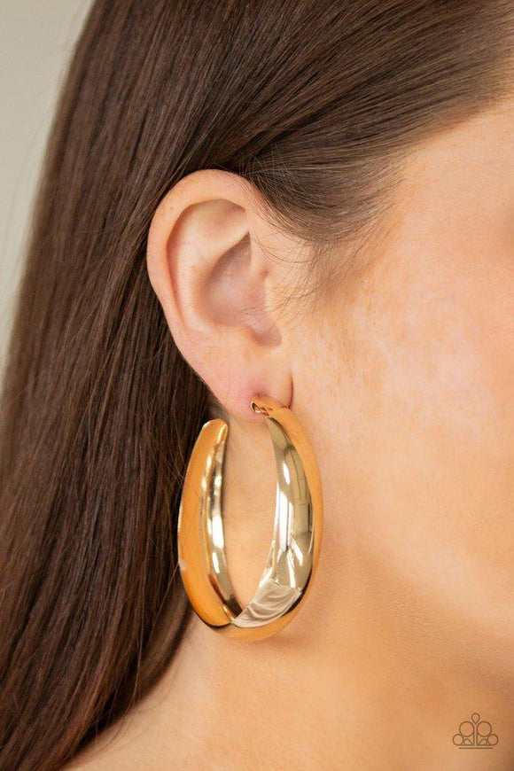 Paparazzi Gypsy Goals - Gold  -  A thick ribbon of glistening gold curls into a dramatic hoop for a bold industrial look. Earring attaches to a standard post fitting. Hoop measures 2 & 1/2 inches� in diameter.
