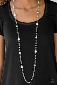 Paparazzi Showroom Shimmer- White Pearly white and faceted silver beads trickle along a bold silver chain, creating a glamorous palette. Features an adjustable clasp closure.

