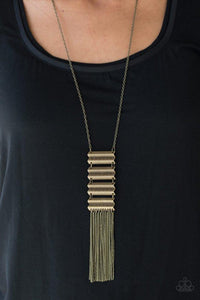 Paparazzi Watch Your Step- Brass Etched in linear and edgy geometric patterns, crimped brass frames climb the torso, linking into a tribal inspired pendant. Swinging from the bottom of a lengthened brass chain, the stacked pendant gives way to a shimmery brass fringe for a seasonal finish. Features an adjustable clasp closure.

