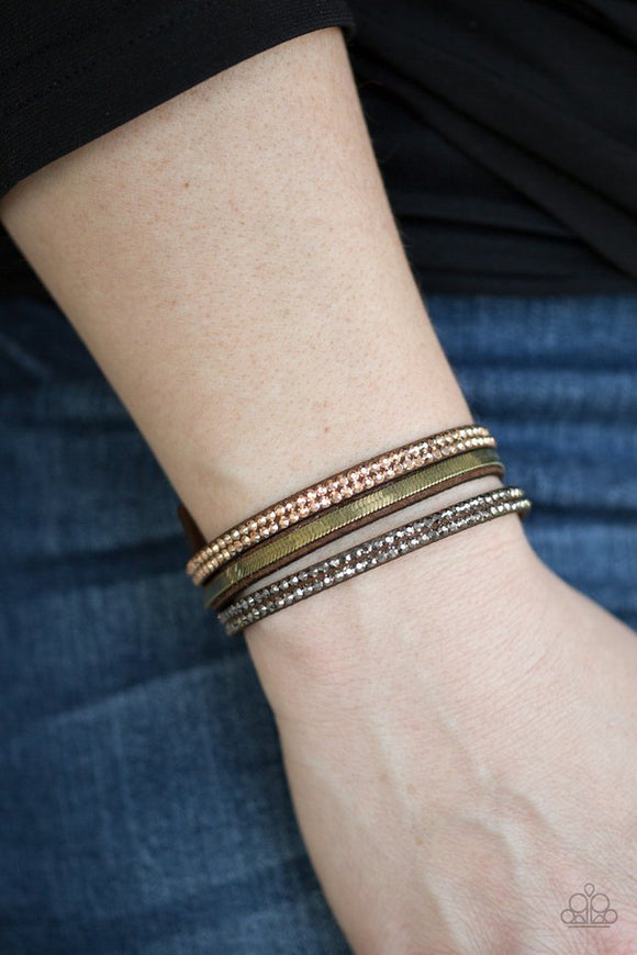 Paparazzi I Mean Business - Multi - Bracelet  -  A brown suede band is spliced into three strands featuring rows of glittery hematite rhinestones, flat brass chain, and faceted metallic rhinestones for a glamorous look. Features an adjustable snap closure.
