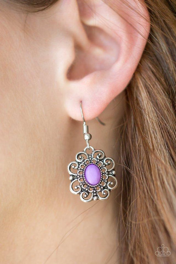 Paparazzi First and Foremost Flowers - Purple A faceted purple bead is pressed into the center of a frilly floral frame for a whimsical look. Earring attaches to a standard fishhook fitting.

