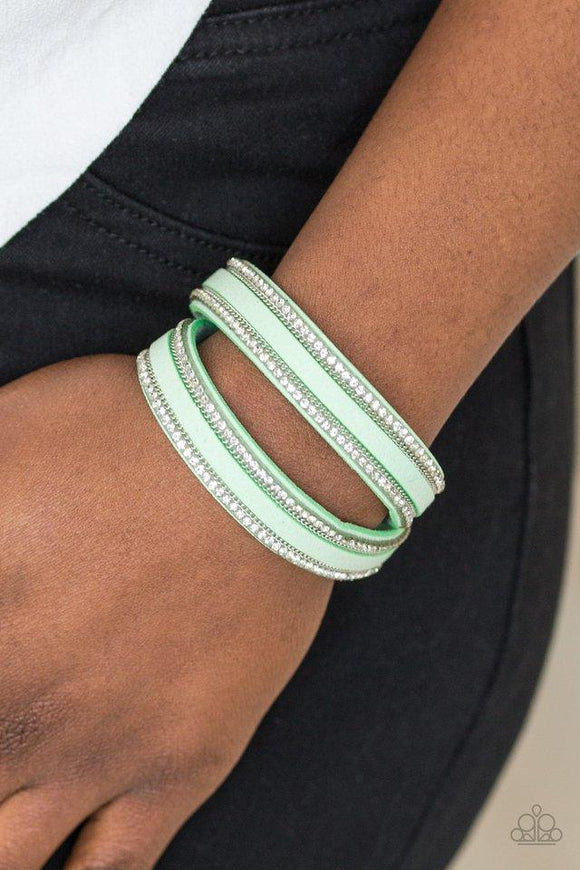 Paparazzi Going For Glam - Green An elongated green suede band is encrusted in rows of glassy white rhinestones and shimmery silver chains. The elongated band double wraps around the wrist for a fierce one-of-a-kind look. Features an adjustable snap closure.

