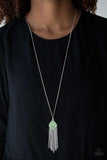 Paparazzi Color Me Capricious- Green A dainty white rhinestone is pressed into the center of a green kite-shaped pendant. Featuring a filigree filled center, the colorful pendant gives way to a whimsical chain tassel for a flirty finish. Features an adjustable clasp closure.

