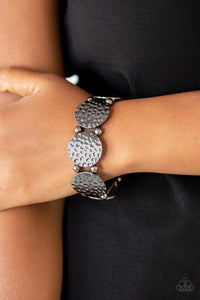Paparazzi GLISTEN and Learn - Black  -  Infused with dainty gunmetal beads, hammered gunmetal frames are threaded along stretchy bands around the wrist for a casual look.
