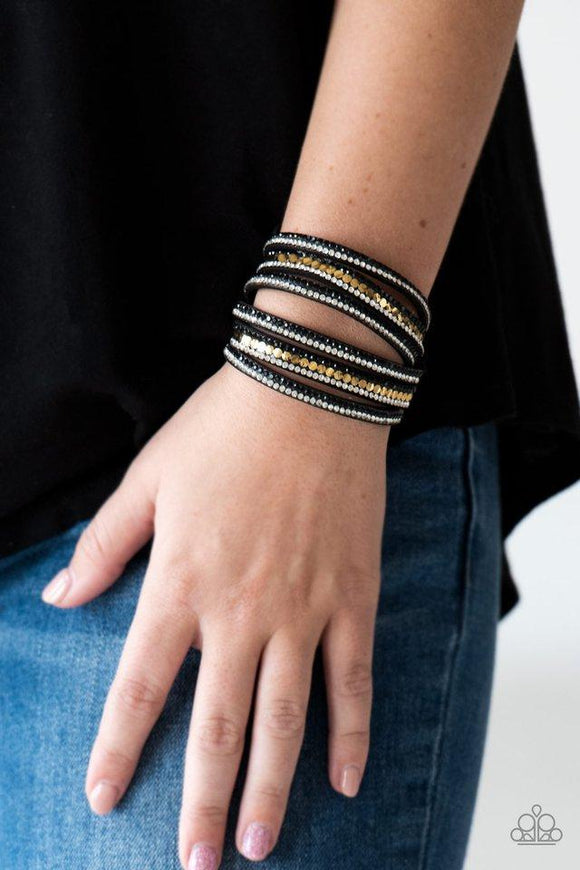 Paparazzi Rock Star Attitude - Black Encrusted in rows of glittery black and white rhinestones and flat gold studs, three strands of black suede wrap around the wrist for a sassy look. The elongated band allows for a trendy double wrap around the wrist. Features an adjustable snap closure.
