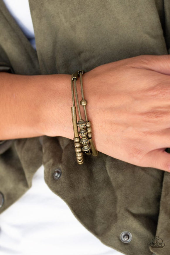 Paparazzi Industrial Instincts - Brass - Bracelet  -  A collection of mismatched brass beads are threaded along three stretchy spring-like wires for a sleek industrial look.
