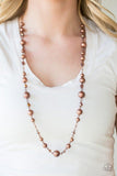 Paparazzi Modernly Majestic - Copper Glistening copper beads and glittery crystal-like beads trickle along a copper chain, creating a refined palette across the chest. Features an adjustable clasp closure.

