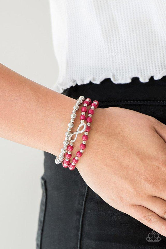 Paparazzi Immeasurably Infinite - Pink Vivacious pink and shiny silver beads are threaded along stretchy bands, creating colorful layers around the wrist. A dainty silver infinity charm adorns one strand for a whimsical finish.

