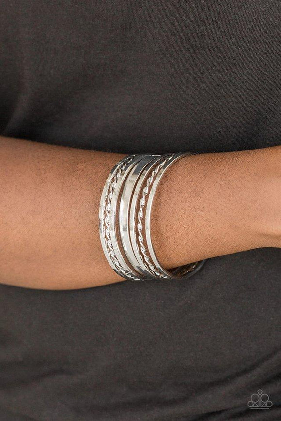 Paparazzi Basic Blend - Silver  -  Featuring smooth and twisted surfaces, mismatched silver bangles stack across the wrist for a casual look.
