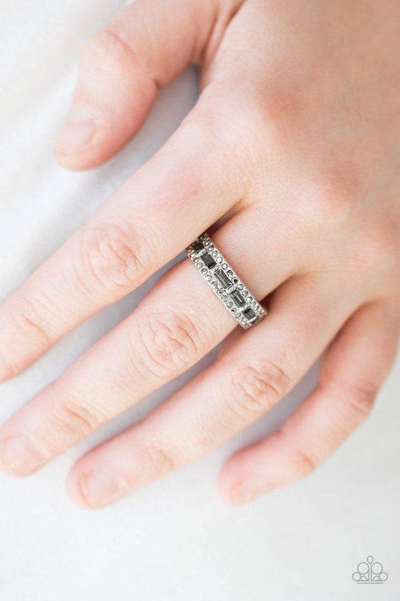 Paparazzi Get The LOOT - Silver Featuring classic round and regal emerald style cuts, smoky and glassy hematite rhinestones are encrusted along a dainty silver band for a refined look. Features a dainty stretchy band for a flexible fit.
