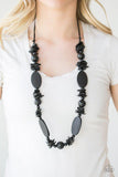 Paparazzi Carefree Cococay - Black  -  Shell-like, round, and flat wooden beads are threaded along shiny black cording, creating a summery palette. Features an adjustable sliding knot closure.
