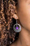 Paparazzi Wandering Waikiki - Purple A flirty purple bead swings from the top of a shimmery silver hoop featuring floral detail for a seasonal look. Earring attaches to a standard fishhook fitting.

