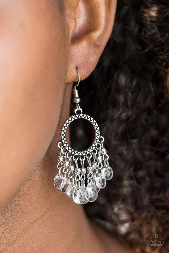 Paparazzi Paradise Palace - White Sparkling white teardrops and faceted silver beads swing from the bottom of a shimmery silver hoop radiating with sunburst patterns for a whimsical look. Earring attaches to a standard fishhook fitting.

