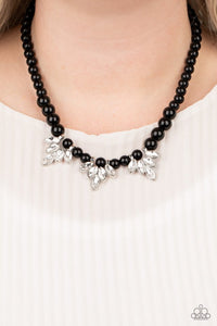 Paparazzi Society Socialite - Black - Necklace  -  A strand of shiny black beads drapes elegantly below the collar. Featuring regal marquise style cuts, glittery white rhinestone frames swing from the beaded strand for a timeless finish. 