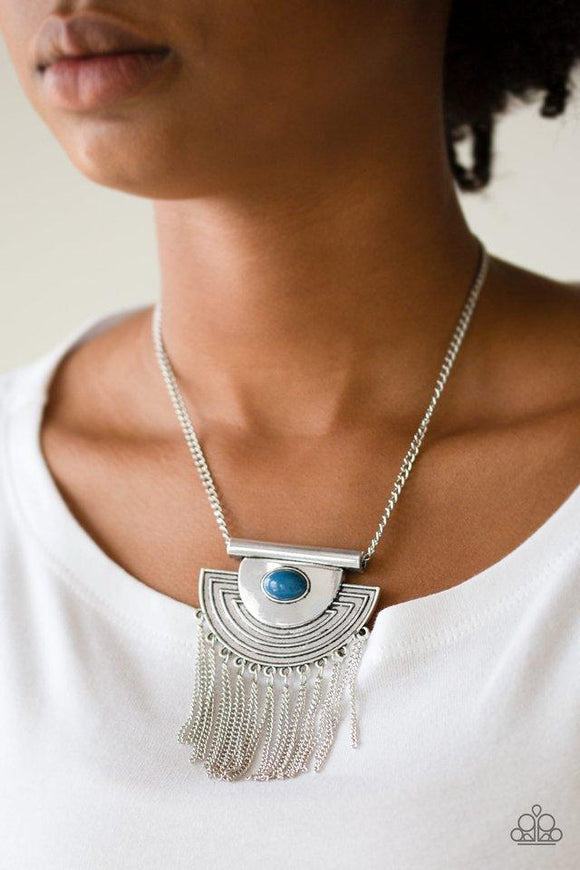 Paparazzi When In ROAM - Blue A refreshing blue bead is pressed into the center of an antiqued silver crescent shaped pendant radiating with geometric patterns. Antiqued silver tassels swing from the bottom of a bold pendant, creating a fierce fringe below the collar. Features an adjustable clasp closure.


