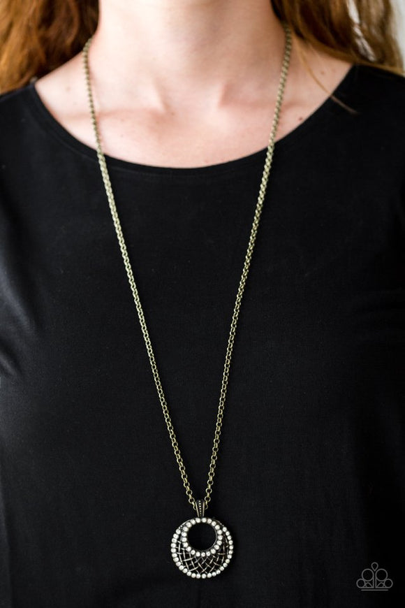 Paparazzi Net Worth - Brass - Necklace  -  Featuring a brass net-like pattern, a white rhinestone encrusted crescent shaped frame swings from the bottom of a lengthened brass chain, creating a refined 3-dimensional pendant. Features an adjustable clasp closure.
