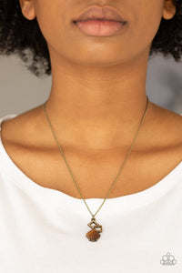 Paparazzi Stylishly Square - Brass - Necklace  -  A topaz rhinestone encrusted square, a shimmery brass square, and a glowing brown moonstone tumble down the chest, coalescing into a stylish pendant. Features an adjustable clasp closure.
