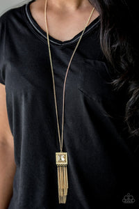 Paparazzi Shimmer Sensei - Gold - Necklace  -  Swinging from the bottom of a lengthened gold chain, a delicately hammered square frame gives way to a shimmery gold fringe. Featuring a regal square cut, a golden gem is pressed into the center of the pendant for an edgy look. Features an adjustable clasp closure.
