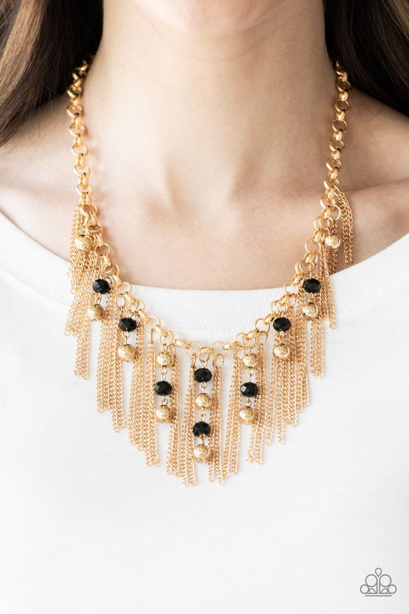Paparazzi Ever Rebellious - Gold - Necklace  -  Glistening gold chains and strands of black crystal-like beads and glistening gold beads stream from the bottom of a bold gold chain, creating a sassy fringe below the collar. Features an adjustable clasp closure.
