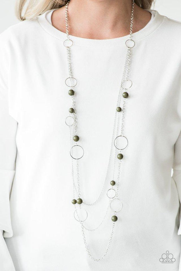 Paparazzi Beachside Babe - Green Featuring earthy green beads and shimmery silver hoops, mismatched silver chains layer down the chest for a seasonal look. Features an adjustable clasp closure.

