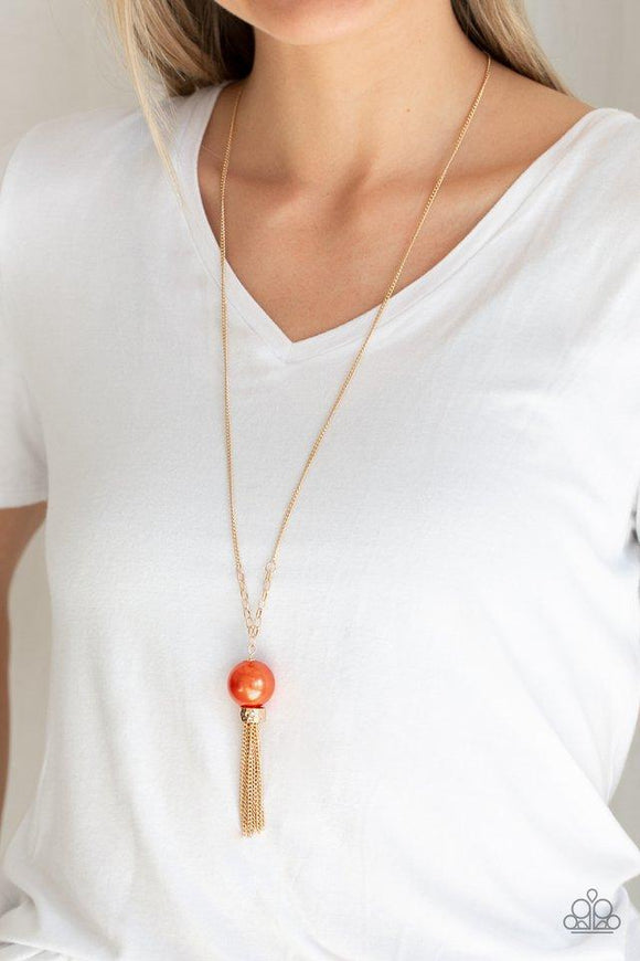 Paparazzi Belle of the BALLROOM - Orange A dramatic pearly orange bead swings from the bottom of an elegantly elongated gold chain. Featuring a hammered fitting, a gold tassel streams from the bottom of the colorful pendant for a refined finish. Features an adjustable clasp closure.
