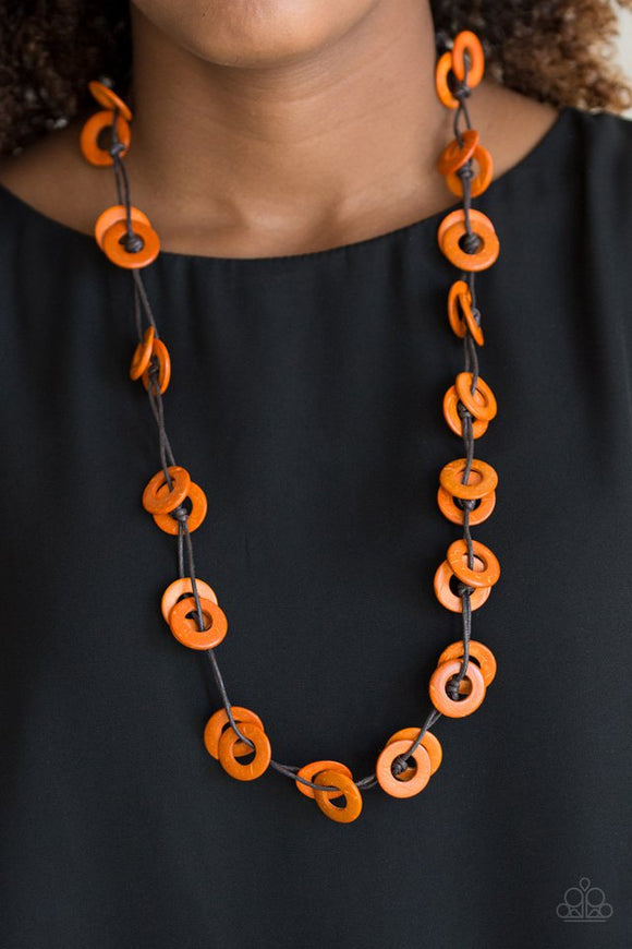 Paparazzi Waikiki Winds - Orange  -  Shiny brown cording knots around vivacious orange wooden discs, creating a colorful display across the chest. Features a button loop closure.
