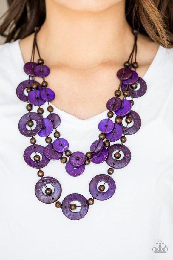 Paparazzi Catalina Coastin - Purple  -  Brushed in a shell-like iridescence, vivacious purple wooden discs and round brown wooden beads are knotted along three strands of brown cording for a summery look. Features a button loop closure.
