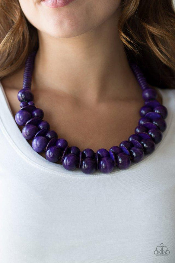 Paparazzi Caribbean Cover Girl - Purple  -  Brushed in a distressed finish, vivacious purple wooden beads and discs join below the collar for a summery look. Features a button loop closure.
