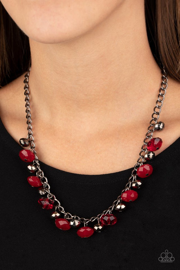 Paparazzi Runway Rebel - Red - Necklace  -  Featuring cloudy and glassy finishes, faceted red crystal-like beads swing from the bottom of a glistening gunmetal chain. Faceted gunmetal beads join the fiery beading, creating a flirtatious fringe below the collar. Features an adjustable clasp closure.

