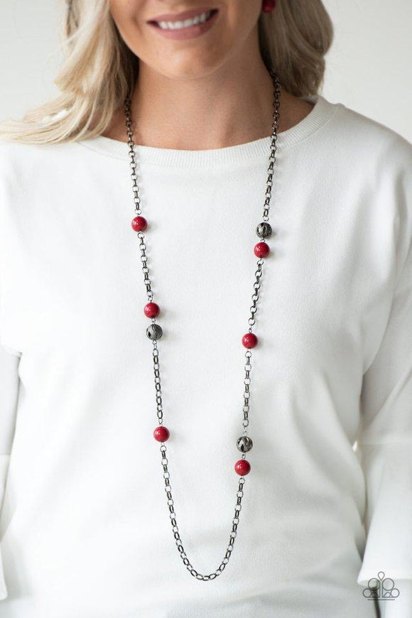 Paparazzi Fashion Fad - Red Rich red beads and ornate gunmetal beads trickle along a bold gunmetal chain, creating a colorfully industrial look across the chest. Features an adjustable clasp closure.

