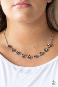 Paparazzi Starlit Socials - Silver Encased in studded silver frames, smoky rhinestones link below the collar for a glamorous look. Features an adjustable clasp closure.

