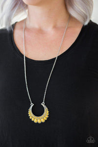 Paparazzi Count To ZEN - Yellow Gradually increasing in size towards the center, dainty yellow beads are encrusted along the center of a silver crescent frame. Yellow beads flare out from the bottom of the shimmery silver frame, creating a bold stationary pendant at the bottom of an elongated silver chain. Features an adjustable clasp closure.


