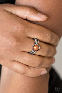 Paparazzi TREK And Field - Brown An earthy brown bead is pressed into the center of a dainty silver band radiating with studded detail for a seasonal look. Features a dainty stretchy band for a flexible fit.
