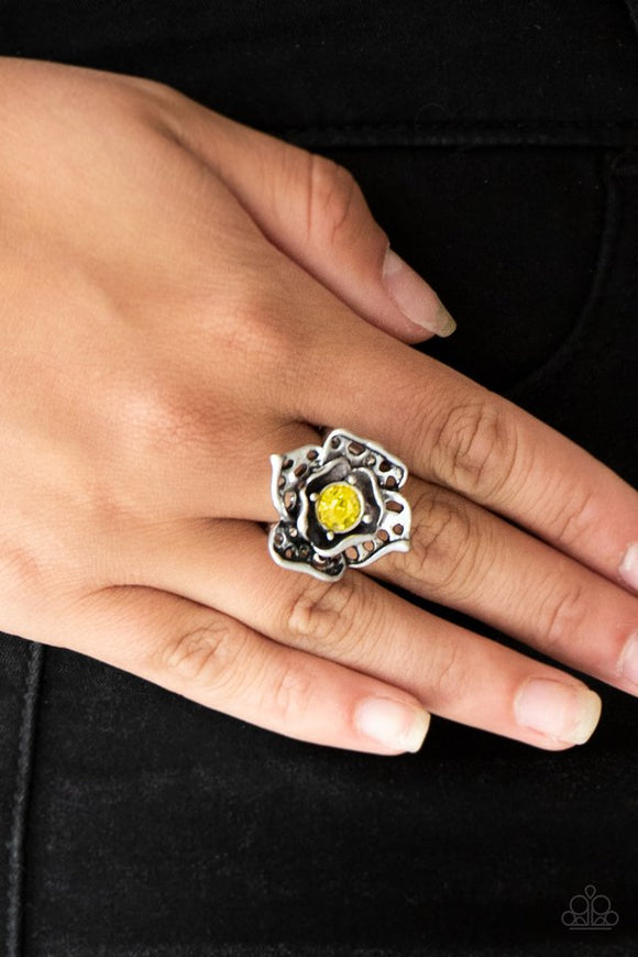 Paparazzi Glowing Gardens - Yellow - Ring  -  Featuring airy cut-out textures, antiqued silver petals gather around a glowing yellow rhinestone center for a whimsical look. Features a stretchy band for a flexible fit.
