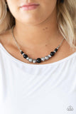 Paparazzi The Big Leaguer- Black A collection of polished black, classic silver, and crystal-like hematite beads are threaded along an invisible wire below the collar for a glamorous look. Features an adjustable clasp closure.

