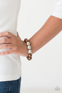 Paparazzi All Dressed UPTOWN - Brown Gradually increased in size near the center, oversized pearly brown and shiny silver beads are threaded along a stretchy band around the wrist for a glamorous finish.

