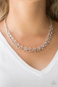 Paparazzi Block Party Princess - Pink A strand of glittery pink crystal-like cube beading joins a classic strand of silver chain below the collar, creating refined layers. Features an adjustable clasp closure.

