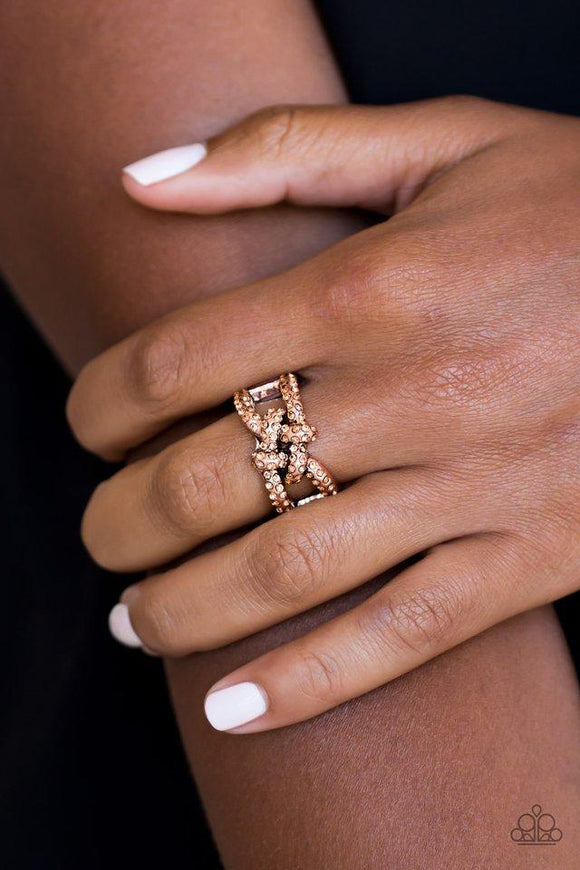 Paparazzi Can Only Go UPSCALE From Here - Copper  -  Encrusted in glittery rhinestones, shimmery copper bars crisscross across the finger, coalescing into a bold square knot atop the finger. Features a stretchy band for a flexible fit.
