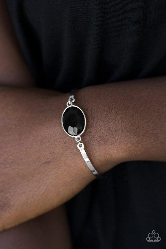 Paparazzi Definitely Dashing - Black Arcing silver bars connect to a faceted black gem centerpiece, creating a dainty cuff-like bracelet around the wrist. Features an adjustable clasp closure.

