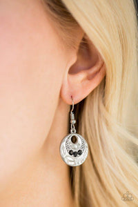 Paparazzi Hard CACHE - Black A trio of glittery black rhinestones are pressed into a delicately hammered silver frame radiating with studded detail for a seasonal look. Earring attaches to a standard fishhook fitting.

