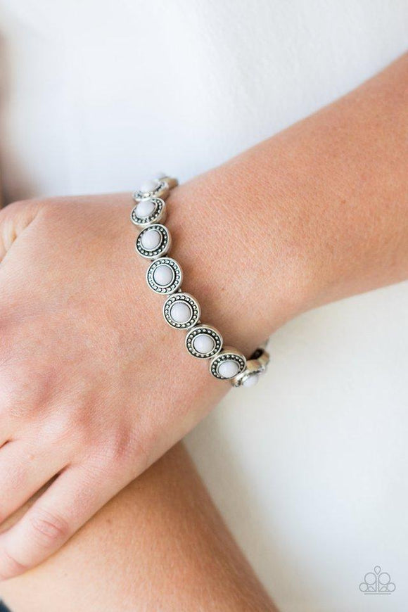 Paparazzi Globetrotter Goals - Silver Dotted with neutral gray beaded centers, studded silver frames are threaded along stretchy elastic bands and linked around the wrist for a whimsical look.
