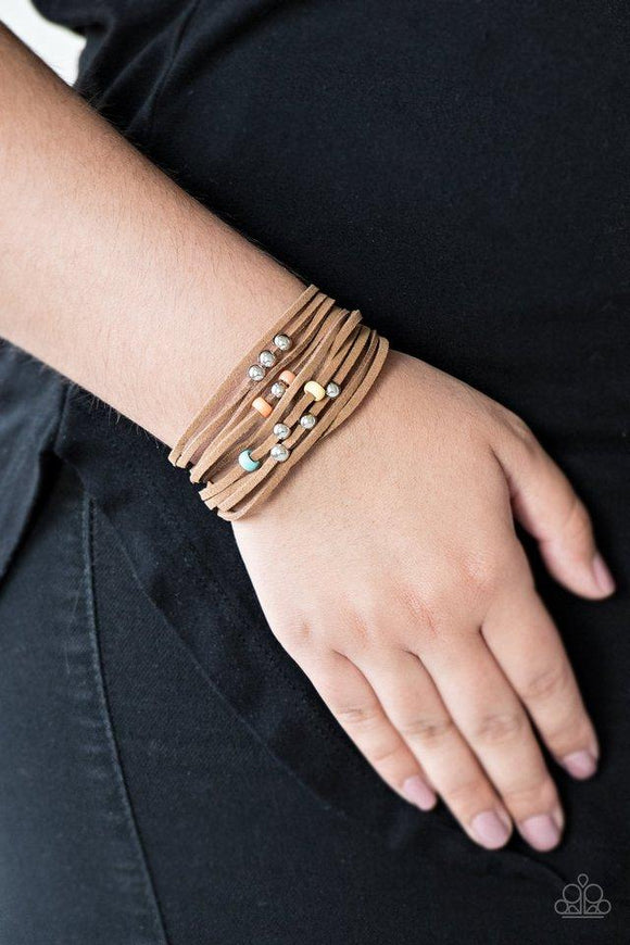 Paparazzi Colorfully Coachella - Multi Dainty multicolored wooden beads and classic silver beads are threaded along strands of brown suede, creating colorful layers across the wrist. Features an adjustable clasp closure.


