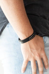 Paparazzi Always An Adventure - Black - Bracelet
Sections of glistening gunmetal studs and stitched white thread adorns the front of a black leather band for an adventurous look. Features an adjustable snap closure.