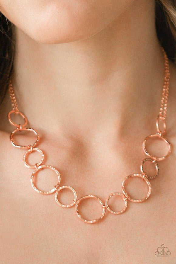 Paparazzi Circus Show - Copper  -  Varying in size, hammered shiny copper hoops link below the collar for a casual look. Features an adjustable clasp closure.
