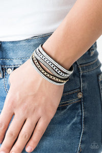 Paparazzi Fashion Fiend - Black - Bracelet  -  Glassy white and smoky rhinestones are encrusted along strands of black suede. Glistening silver and gold chains are added to the bands, adding edgy industrial shimmer to the sassy palette. Features an adjustable snap closure.
