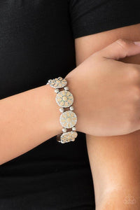 Paparazzi Dancing Dahlias - Brown Painted in a neutral brown finish, ornate silver floral frames are threaded along a stretchy band across the wrist for a seasonal look.

