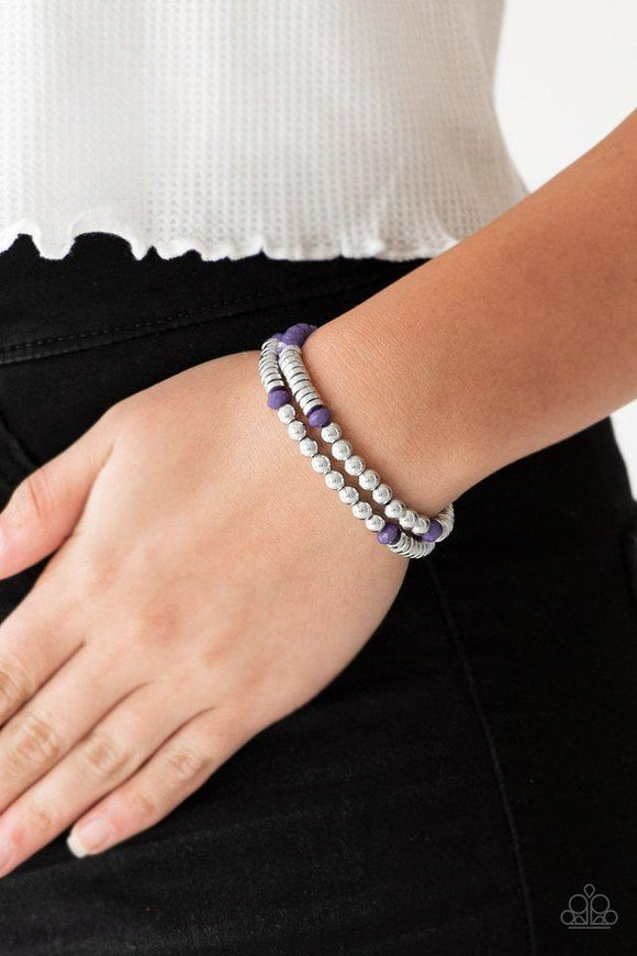 Paparazzi Downright Dressy - Purple  -  Classic silver beads, faceted purple beads, and dainty silver discs are threaded along stretchy bands, creating shimmery layers across the wrist.
